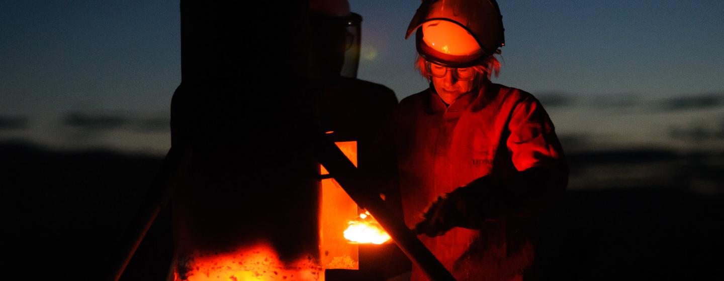 Image of person in protective clothing using a furnace