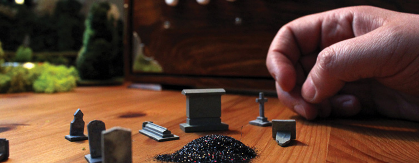 A hand moves small games like counters on a table