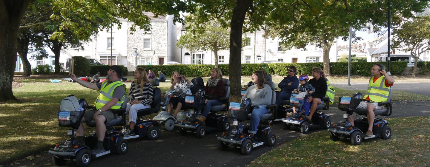 A group of people on mobility scooters