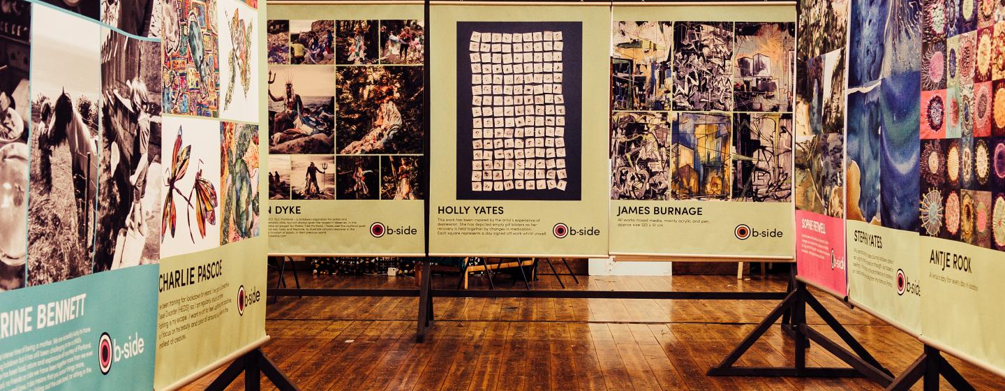 Three rows of very large posters with artworks and artist names