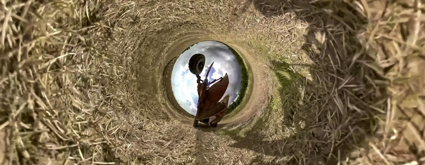 An image of a harvest machinery in a tube of hay