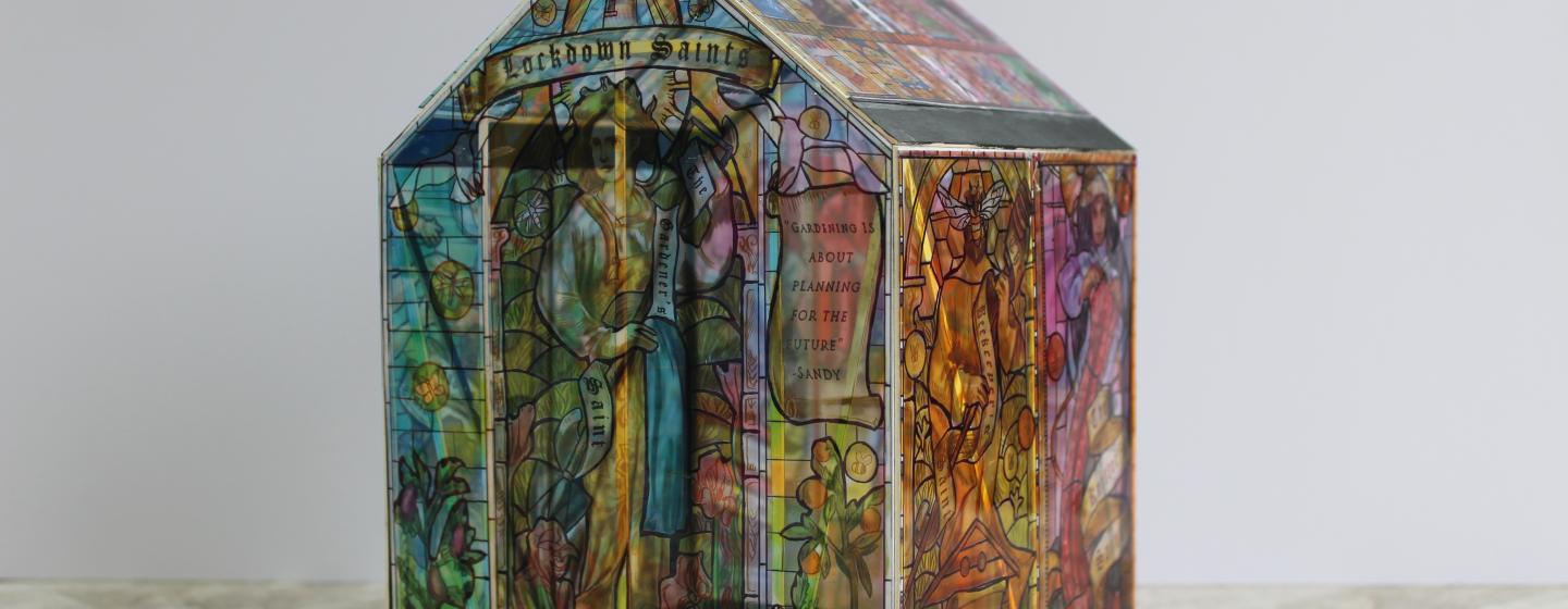 An image of a model house made using stained glass