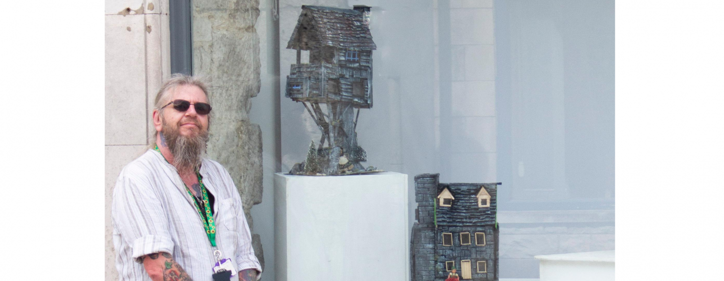 A man standing next to a window
