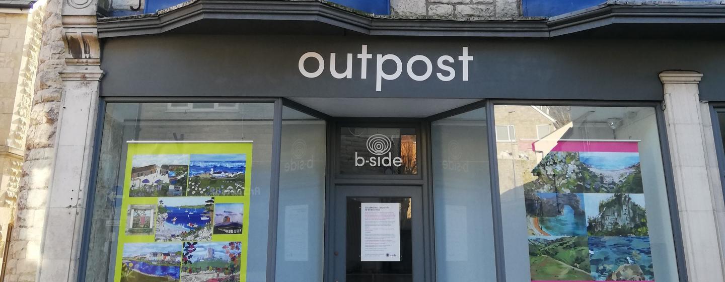 A photograph of the outside of the b-side project space on Portland exhibitiing large colourful posters created by Portland residents