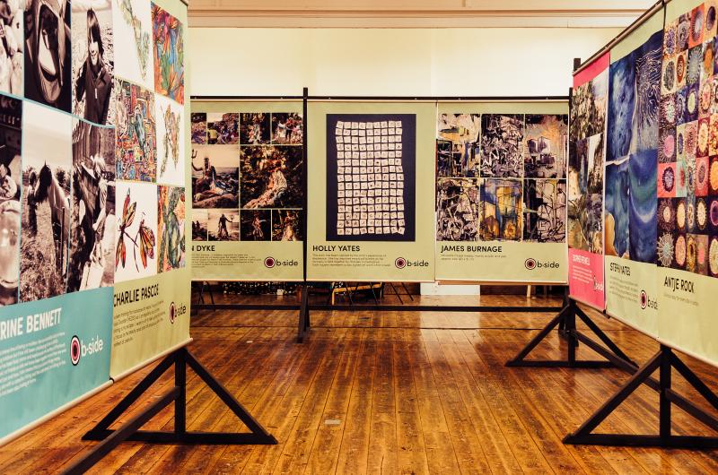 Three rows of very large posters with artworks and artist names
