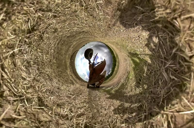 An image of a harvest machinery in a tube of hay