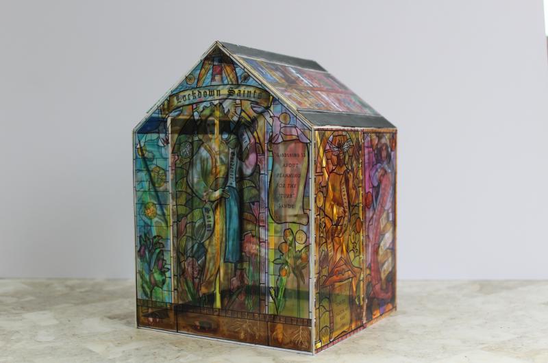 An image of a model house made using stained glass