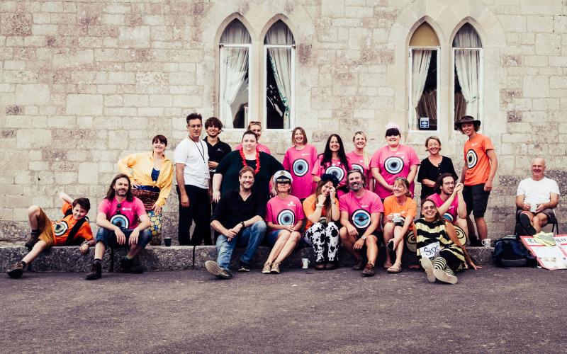 A group of people all posing for the camera in front of the b-side Festival Hub