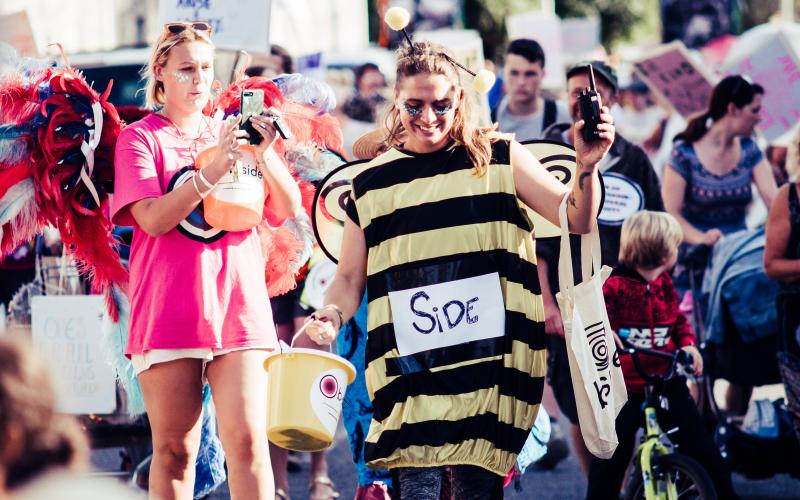 A group of people dressed up, with the leader dressed as a bee