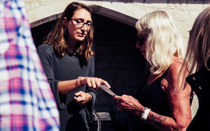 Two people looking at a piece of paper, in conversation